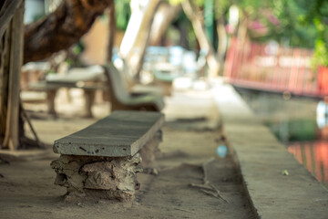 The blurry background of the chairs made of cement, to sit in the park or inside various temples, to facilitate the people who use the service