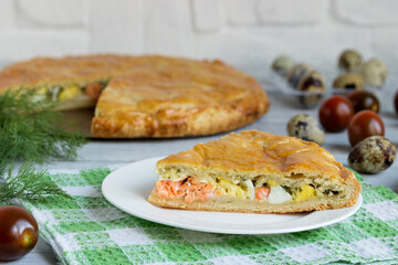 A slice of homemade pie with eggs, salmon and green onions.