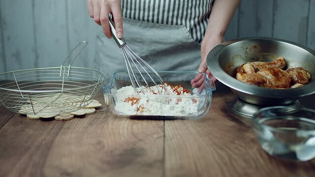 Adding flour into a glass bowl along with 1 TBSP of Salt, Soya sauce, Tomato Ketchup, Ginger paste, Garlic paste, Chilli paste, Black pepper powder. Concept of preparing the breading for juicy Chicken