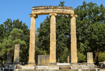 Pillar and columns of ancient Greek shrine in Olympia. Remains of classic Greek civilization in Olympia