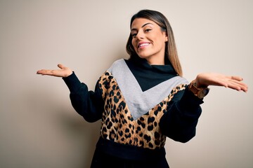 Young beautiful woman wearing casual sweatshirt standing over isolated white background clueless...