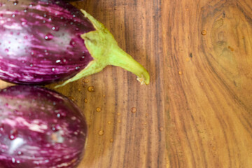 Brinjals, Eggplant, or  Aubergine, on Wooden Background