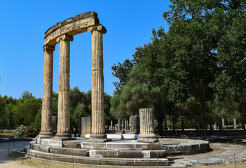 Round shrine ruins with columns and pillars in the ancient hellenistic Greek ruins of Olympia, Greece.
