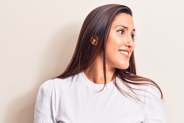 Fototapeta premium Young beautiful brunette woman wearing casual t-shirt looking to side, relax profile pose with natural face and confident smile.