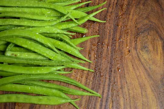 Cluster Bean or  GuarAlso Known as Gavar, Guwar or Guvar Bean isolated on Wooden Background