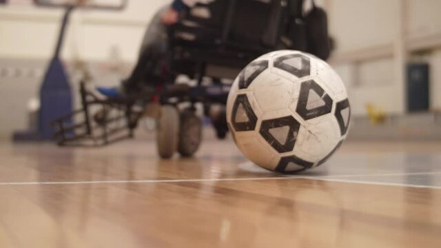 motorized wheelchair paralympic power soccer players playing slow motion