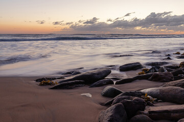 Dawn view around the beach coastline with big rocks.