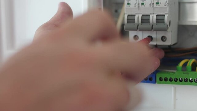 electrician tighten screw in circuit breaker  with screwdriver slow motion
