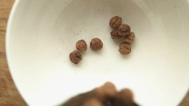 Chocolate Corn Balls Falling Into bowl  Slow Motion. chcolate ceral Breakfast.