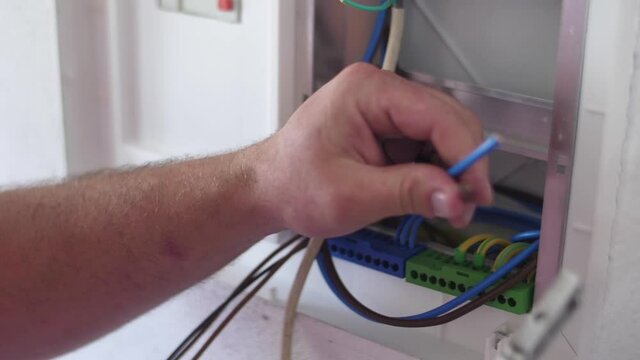 strip electrical wire with plier in electric instalation slow motion