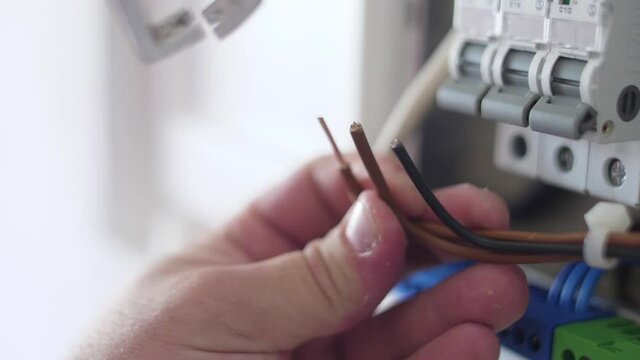 strip electrical wire with plier in electric instalation slow motion