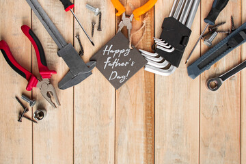 Set of work tools on a wooden background. Festive greeting card concept for Father's day.