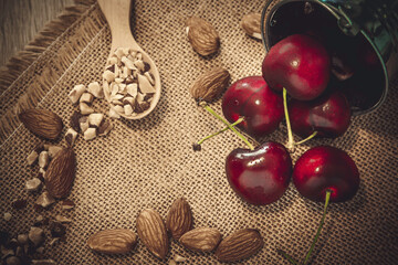 red cherry and ground almonds for sprinkling sweet food in a wooden spoons