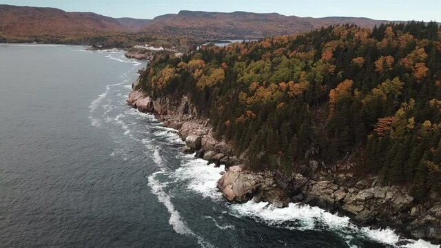 Stunning views of the Atlantic Ocean along the coasts of Cape Breton along the Cabot Trails, Nova Scotia during Autumn. Fall foliage  with multi colored deciduous trees Middlehead Trail.	