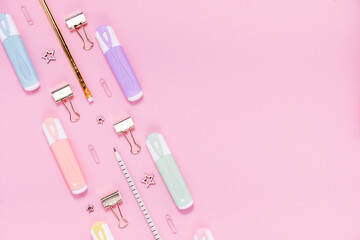 Back to school concept notepad, pencil case, stationery and school supplies. Top horizontal view copyspace pink abstract background