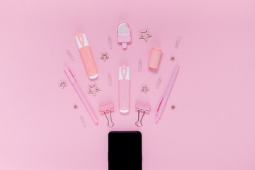 Back to school concept notepad, pencil case, stationery and school supplies. Top horizontal view copyspace pink abstract background