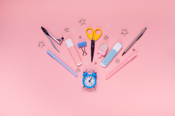 Back to school concept notepad, pencil case, stationery and school supplies. Top horizontal view copyspace pink abstract background