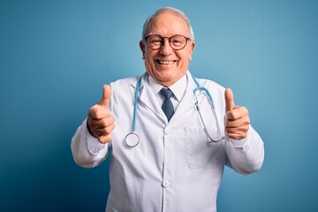 Senior grey haired doctor man wearing stethoscope and medical coat over blue background success...