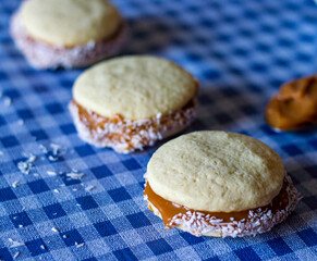 three Uruguayan dulce de leche alfajores with grated coconut
