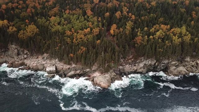 Stunning views of the Atlantic Ocean along the coasts of Cape Breton along the Cabot Trails, Nova Scotia during Autumn. Fall foliage  with multi colored deciduous trees Middlehead Trail.	