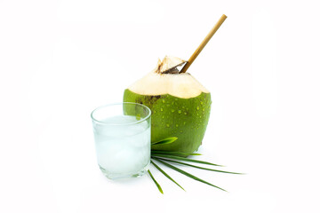 A glass of coconut water with green coconut on a white background.