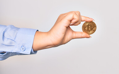 Hand of caucasian young woman holding golden bitcoin money over isolated white background