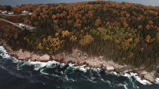 Stunning views of the Atlantic Ocean along the coasts of Cape Breton along the Cabot Trails, Nova Scotia during Autumn. Fall foliage  with multi colored deciduous trees Middlehead Trail.	