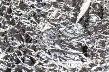 thin and crumpled shiny aluminum foil,
