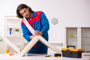 Young male carpenter working indoors