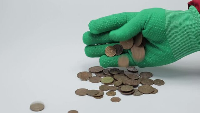a pile of old USSR coins and a gloved hand