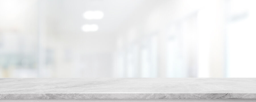 Empty white marble stone table top and blur glass window interior lobby and hall way banner mock up abstract background - can used for display or montage your products.