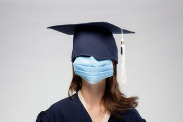 Graduation girl portrait, vearing medical mask. Self isolation, quarantine, virtual graduation concept