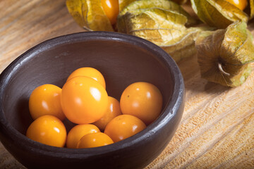 Golden Berries, Close up detail of clay pot