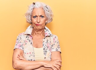 Senior grey-haired woman wearing casual clothes skeptic and nervous, disapproving expression on...