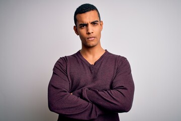 Young handsome african american man wearing casual sweater over white background skeptic and...