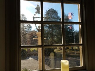 candle, thick glass window, and flag outdoor
