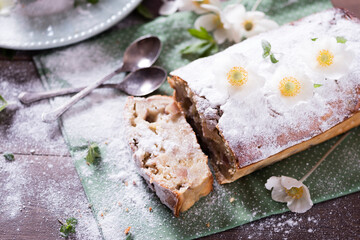 Homemade  apple pie on the green napkin decorated with fresh red  apples,, mint leaves. Vegetarian tart on the wooden background. Delicious autumn dessert.