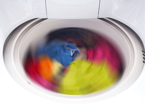 White Washing Machine With Clothes Spinning