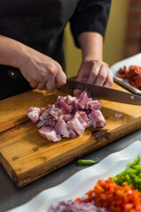 Cutting raw meat in the kitchen