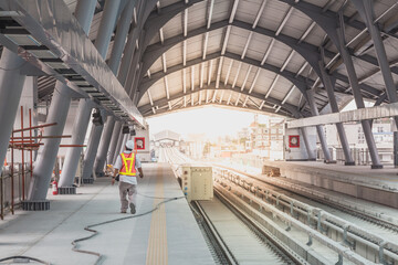 Inspector (Engineer) checking railway construction work in skytrain station.