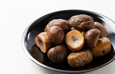 Peeled sweet chestnuts on a white background