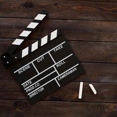 Filmmaking concept. Movie Clapperboard. Cinema begins with movie clappers. Movie clapper board on a wooden background. Square.