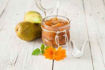 jam from a pear in a jar on a table, selective focus