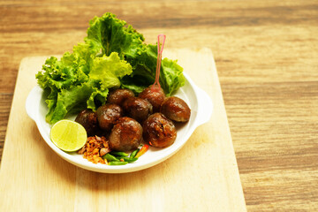 Tapioca balls with pork filling,pepper,fried garlic,lemon slide and green vegetable
