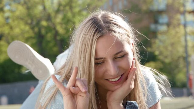 A blond teenage girl recording a TikTok challenge video.
