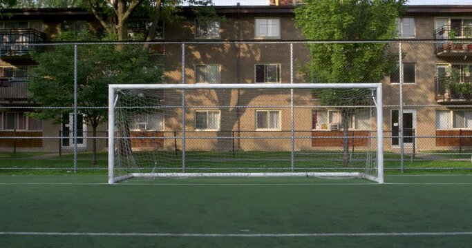 Static shot of a centered soccer goal with a ball missing the net