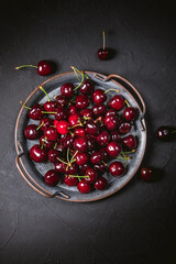 Fresh cherries in bowl on table