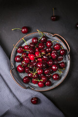 Fresh cherries in bowl on table