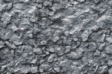 White stone wall with rough bulges.