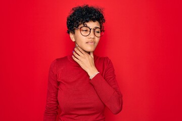 Obraz na płótnie Canvas Young beautiful african american afro woman wearing turtleneck sweater and glasses Touching painful neck, sore throat for flu, clod and infection